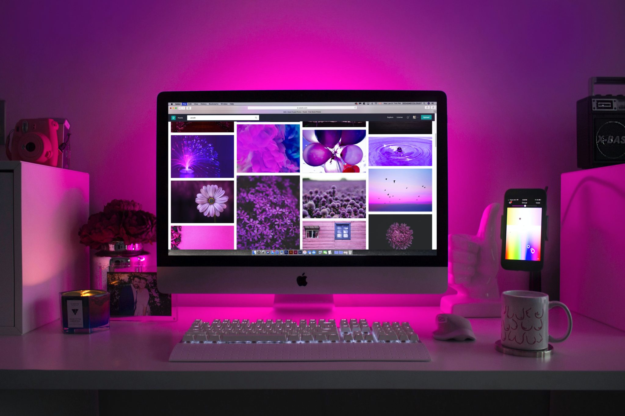 A picture of a home office desk where a computer monitor displays a series of pictures in blocks - not unlike the way a content management system helps users create websites without technical experience.