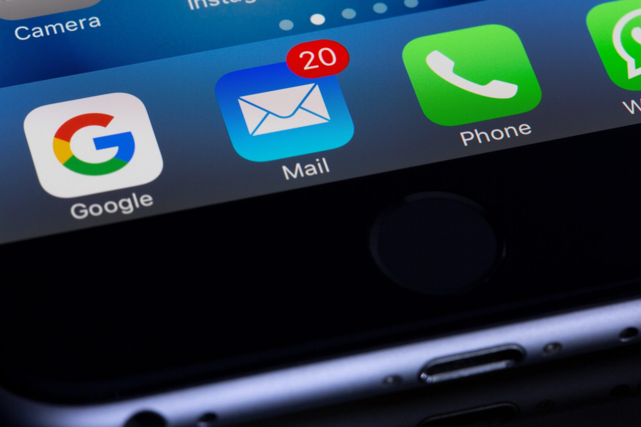 A picture of the bottom of a phone showing apps like Google and email which are web applications.